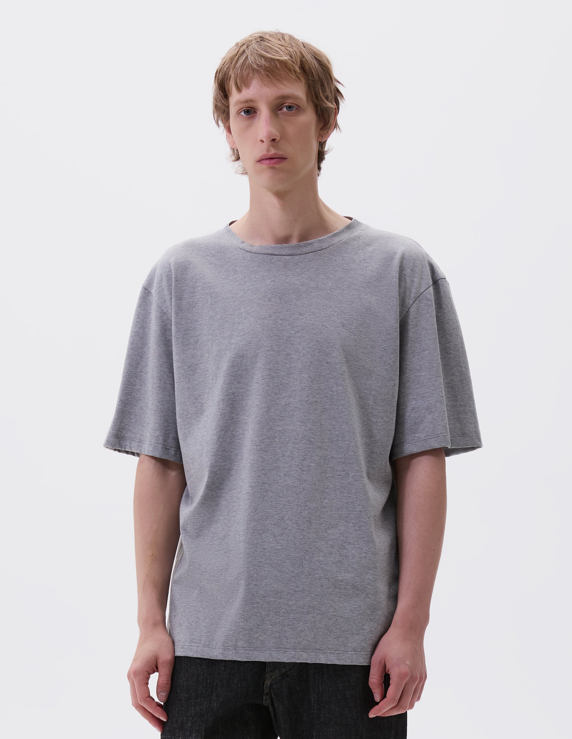 Cropped body image, front view with grey cotton short sleeve t-shirt. Styled with black denim jeans.