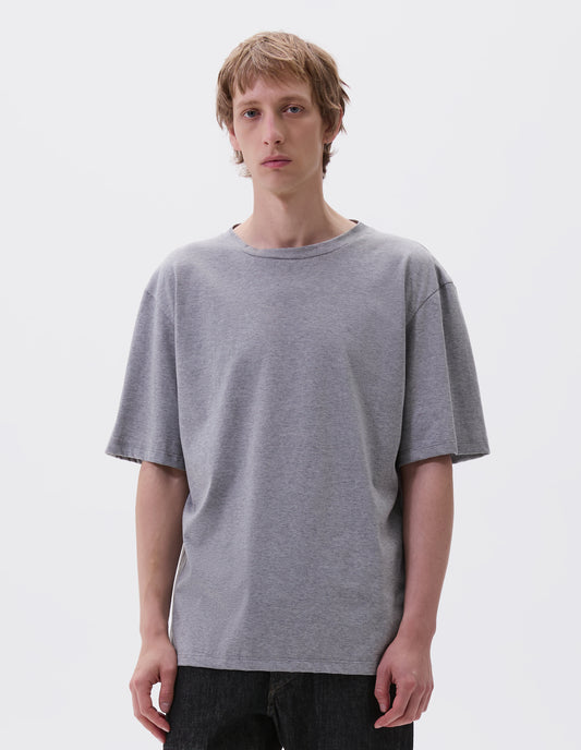 Cropped body image, front view with grey cotton short sleeve t-shirt. Styled with black denim jeans.