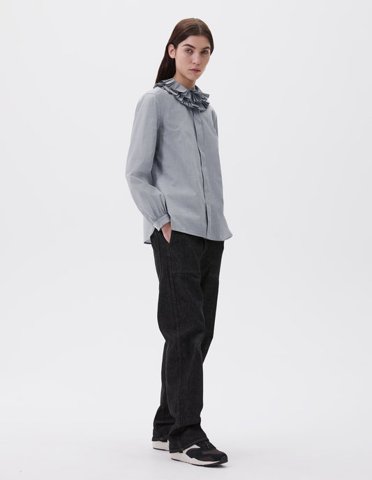 Full body image, front view of model wearing Grey long sleeve shirt with ruffled collar, concealed placket and shirt cuffs. Styled with black denim jeans and black and brown trainers.