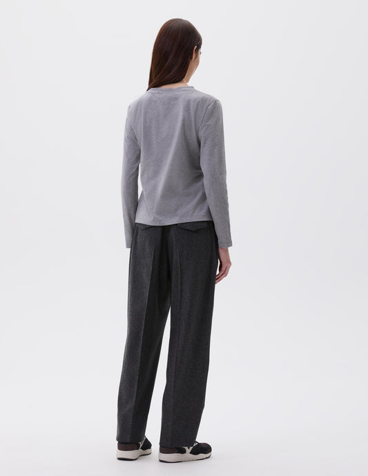 Full body image, back view of model wearing grey cotton wide neck long sleeve with boxy cut. Styled with charcoal grey trousers and black and brown trainers.