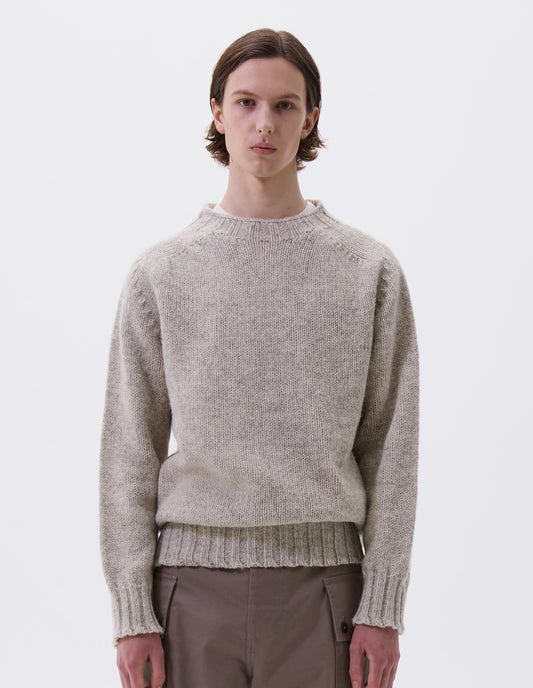 Cropped body image, front view of model wearing beige marl jumper with saddle sleeves and contrasting rib on neck, cuffs and hem. Styled with beige trousers.