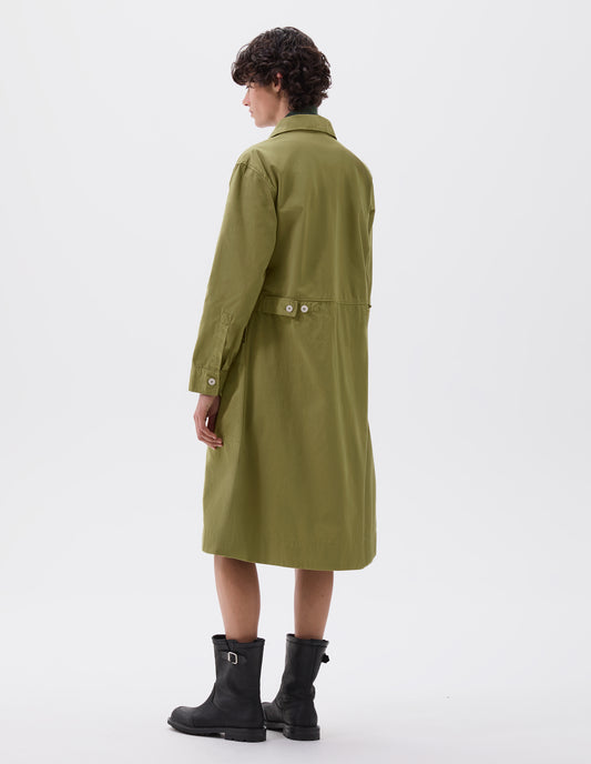 Full body image, back view of model wearing green long sleeve shirt dress with deep stitch hem and waist seam detail with button tab adjusters. Styled with black leather biker boots.
