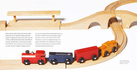 A double page spread showcasing the wooden Micki Leksaker railway set.