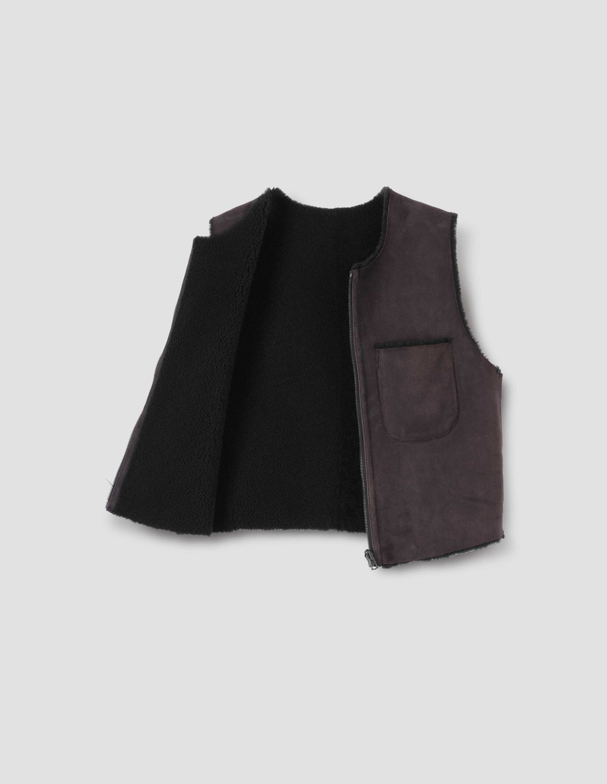 Brown and black reversible sleeveless gilet with patch pocket, zip closure and raw edge finish on neck, armhole and hem. Front open flat lay view.