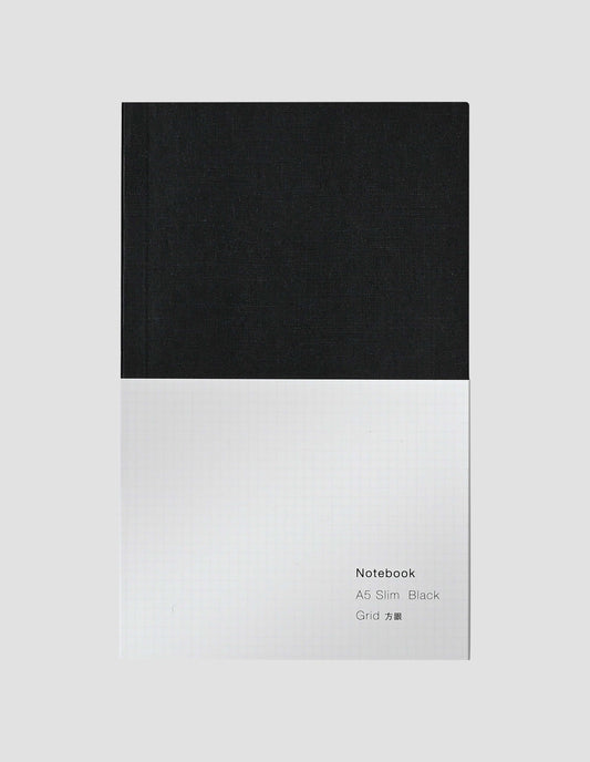 A flat lay view of the black notebook with white wrap around label.