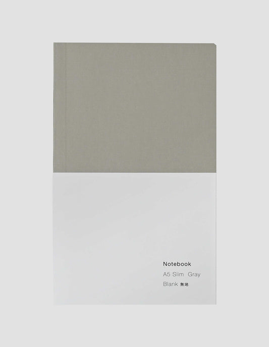 A flat lay view of the grey notebook with white wrap around label.
