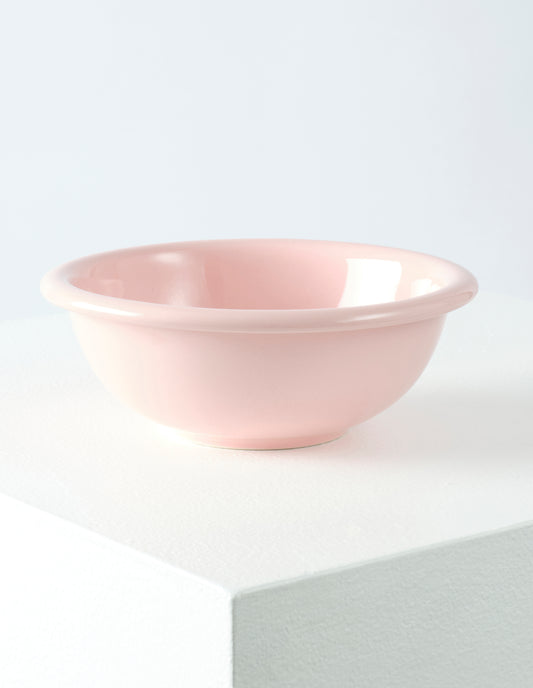A single pink high gloss stoneware Bronto bowl on a white plinth.