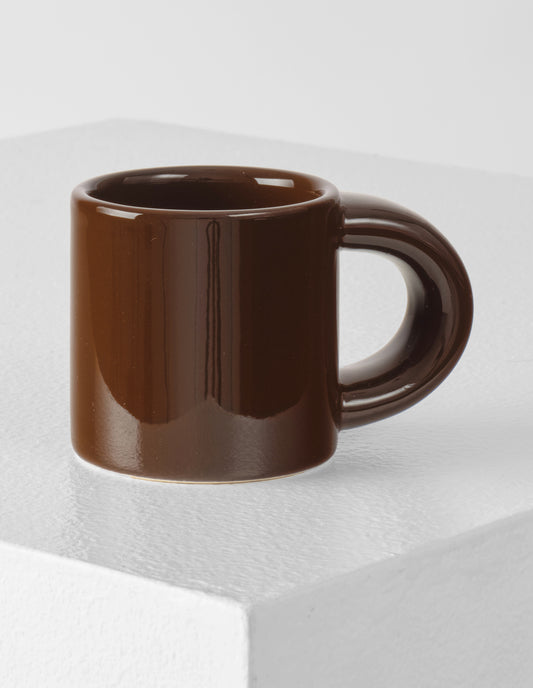 A single brown Bronto espresso cup with the high gloss glaze bringing our attention to the exaggeratedly chunky handle.