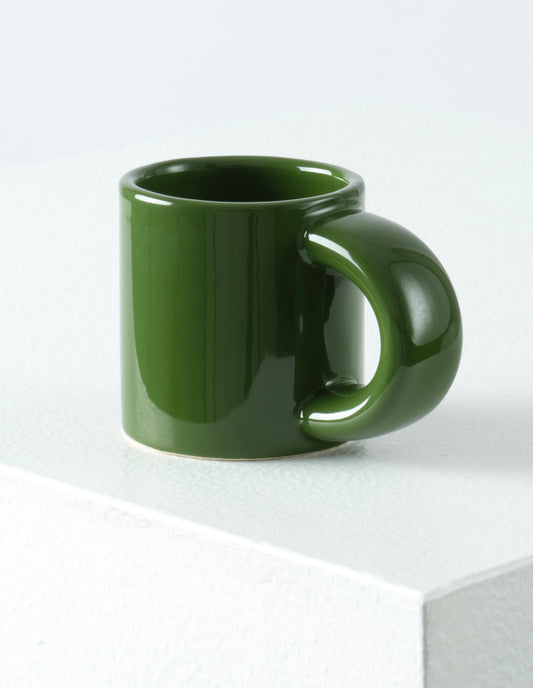 A single green Bronto espresso cup with the high gloss glaze bringing our attention to the exaggeratedly chunky handle.