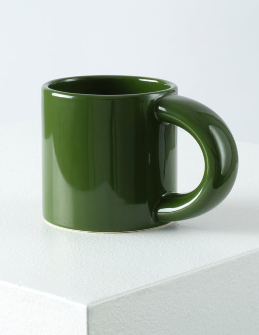 A single green Bronto mug with the high gloss glaze bringing our attention to the exaggeratedly chunky handle.