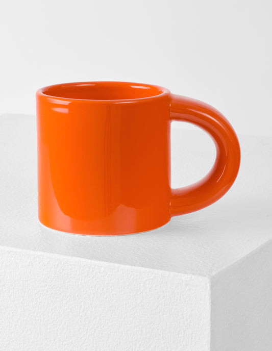 A single orange Bronto mug with the high gloss glaze bringing our attention to the exaggeratedly chunky handle.