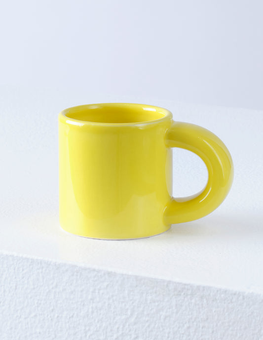 A single yellow Bronto mug with the high gloss glaze bringing our attention to the exaggeratedly chunky handle.