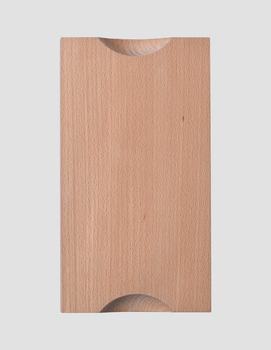A flat lay view of the under side of the natural beech wood chopping board clearly showing the two cut away semi circles that make the board easy to lift.