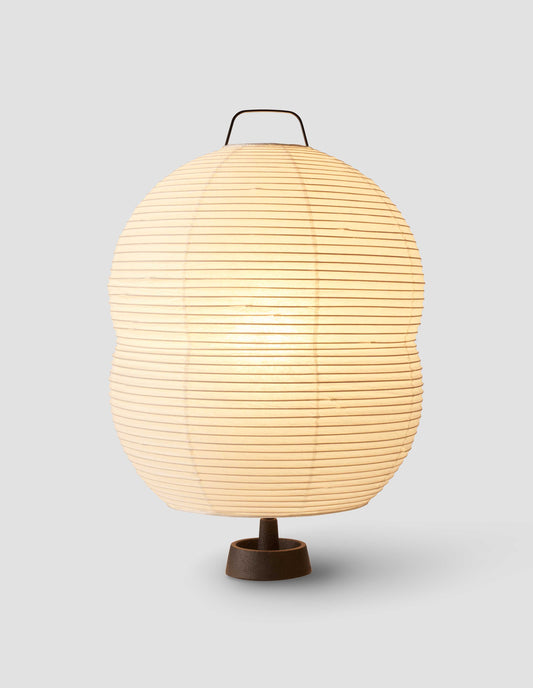 A Hotaru handmade mulberry bark off white washi paper mini double bubble table light switched on emitting a soft glow of diffused light.