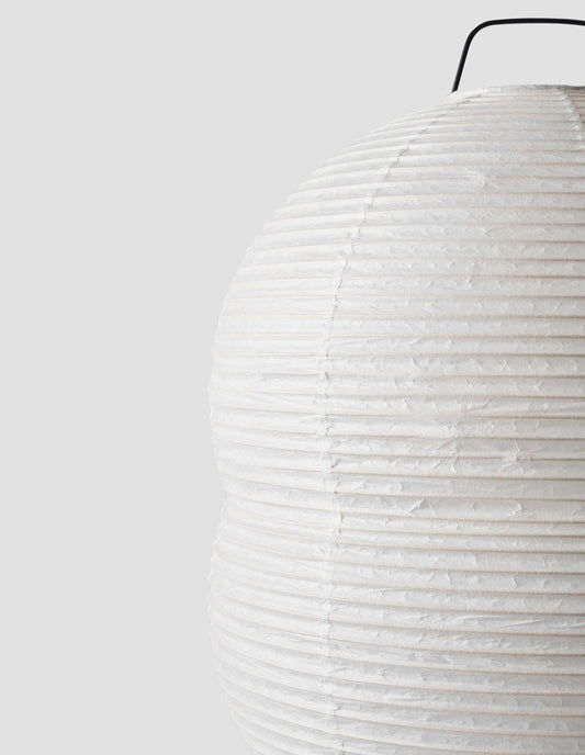 A close up view of the body of the Hotaru mini double bubble table light showing the texture of the off white translucent handmade mulberry bark washi paper over the bamboo frame.