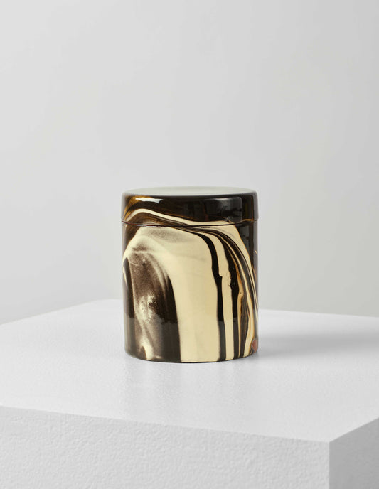 Front flat lay of a round ceramic white and brown marbled storage jar with lid on.