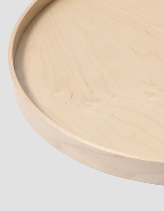 A close up of the rim of the round tray showing the layer of birch ply.