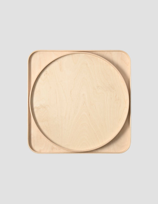 A top down view of the Isokon round tray sitting inside the Isokon square tray.