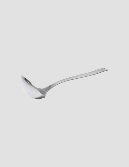 A side view of the upright satin finish stainless steel ladle showing the gentle curve of the ergonomically designed  handle.