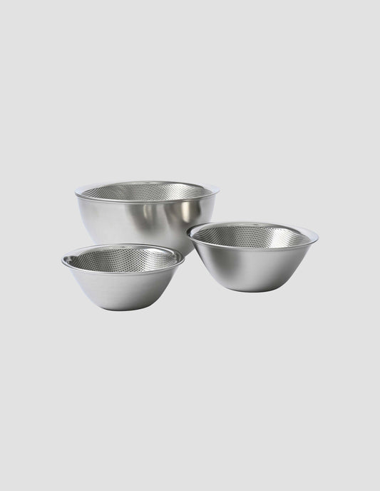 The group of small, medium and large bowls. their strainers neatly fitted inside, with the lip of the strainer gently curving outwards for ease of use.
