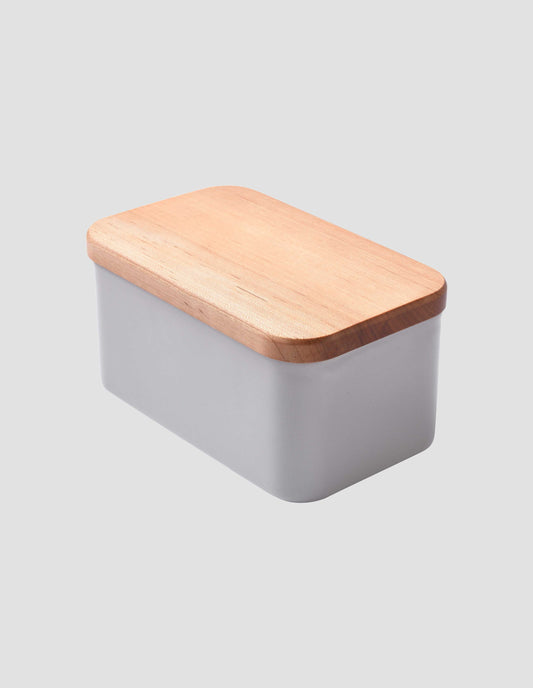 An angled view showcasing the beautiful cherry wood flat lid on the large grey enamel butter dish.
