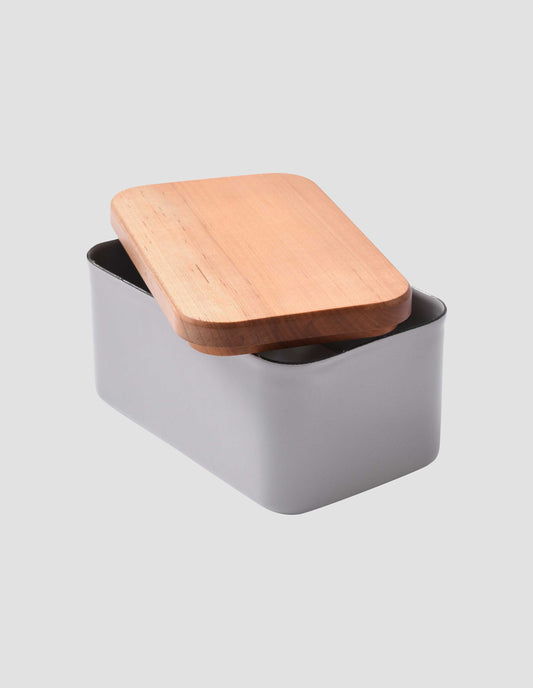 The cherry wood lid removed and placed at an angle on top of the large grey enamel butter dish.