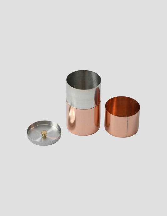 A shiny new copper long tea caddy showing both inner and outer lids removed to see the tinplate inner structure.