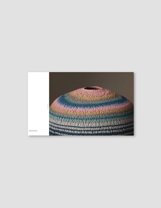 An image from the book featuring a photograph of a colourful ceramic artwork in the centre, with the artwork details displayed on the left against a white background. Flat lay image on a light grey background.