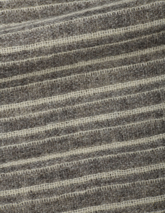 A close up view showing in detail the delicately woven grey and white stripes.