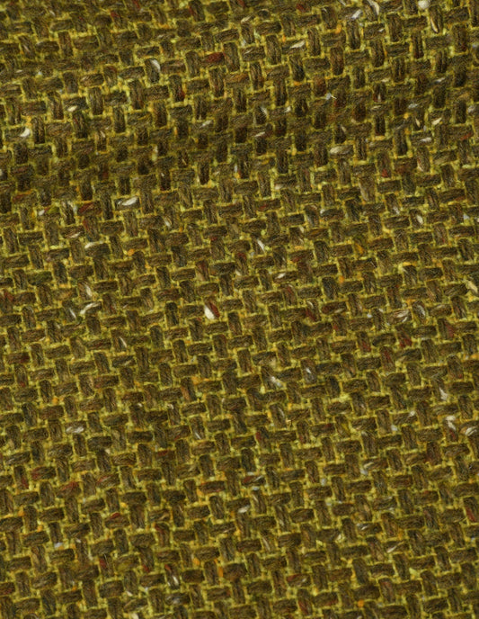 A close up view showing in detail the texture and intricate pattern created by the thick and thin woven earthy greens and browns with a subtle touch of brighter yellow and orange-flecked yarns.