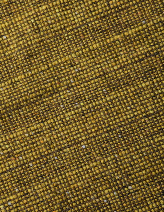 A close up view showing in detail the woven pattern created by the blend of rich, earthy brown, with  flecks of sand and beige and subtle yellow yarn with hints of green.