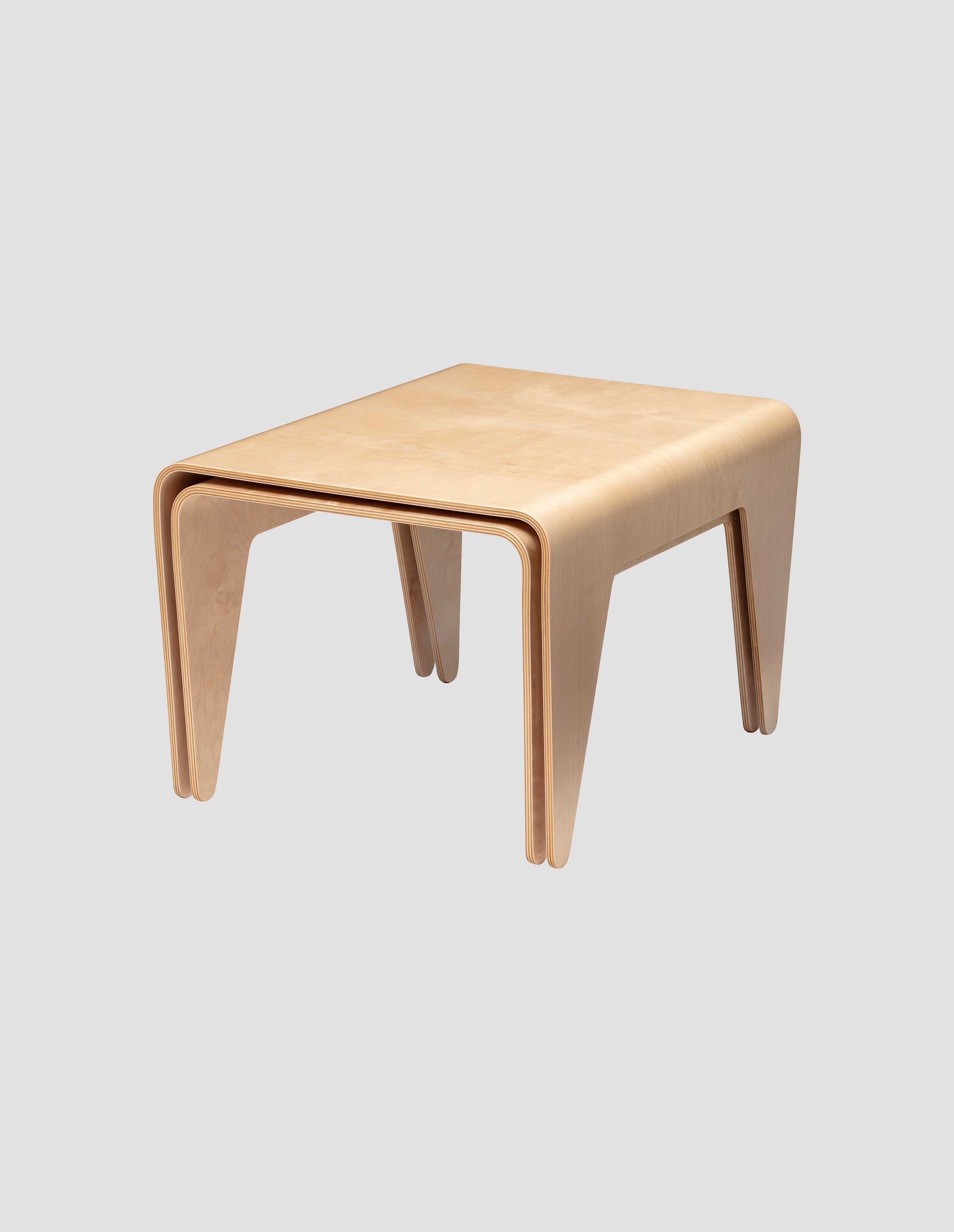 The medium and large nesting tables perfectly nested together on a white background.