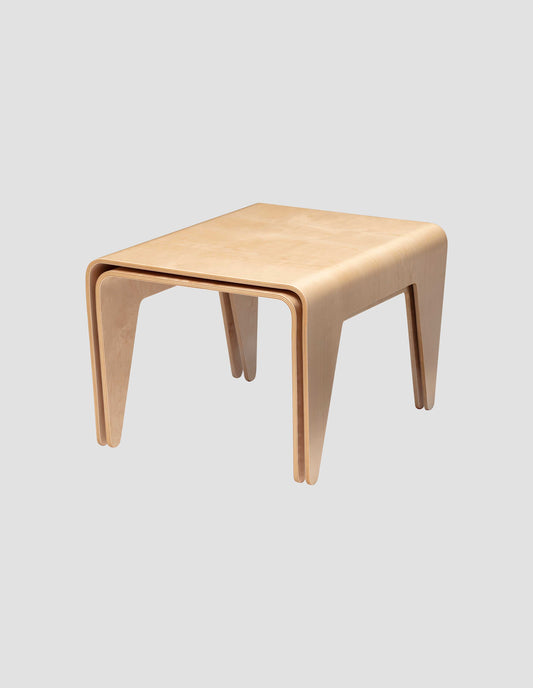 The medium and large nesting tables perfectly nested together on a white background.