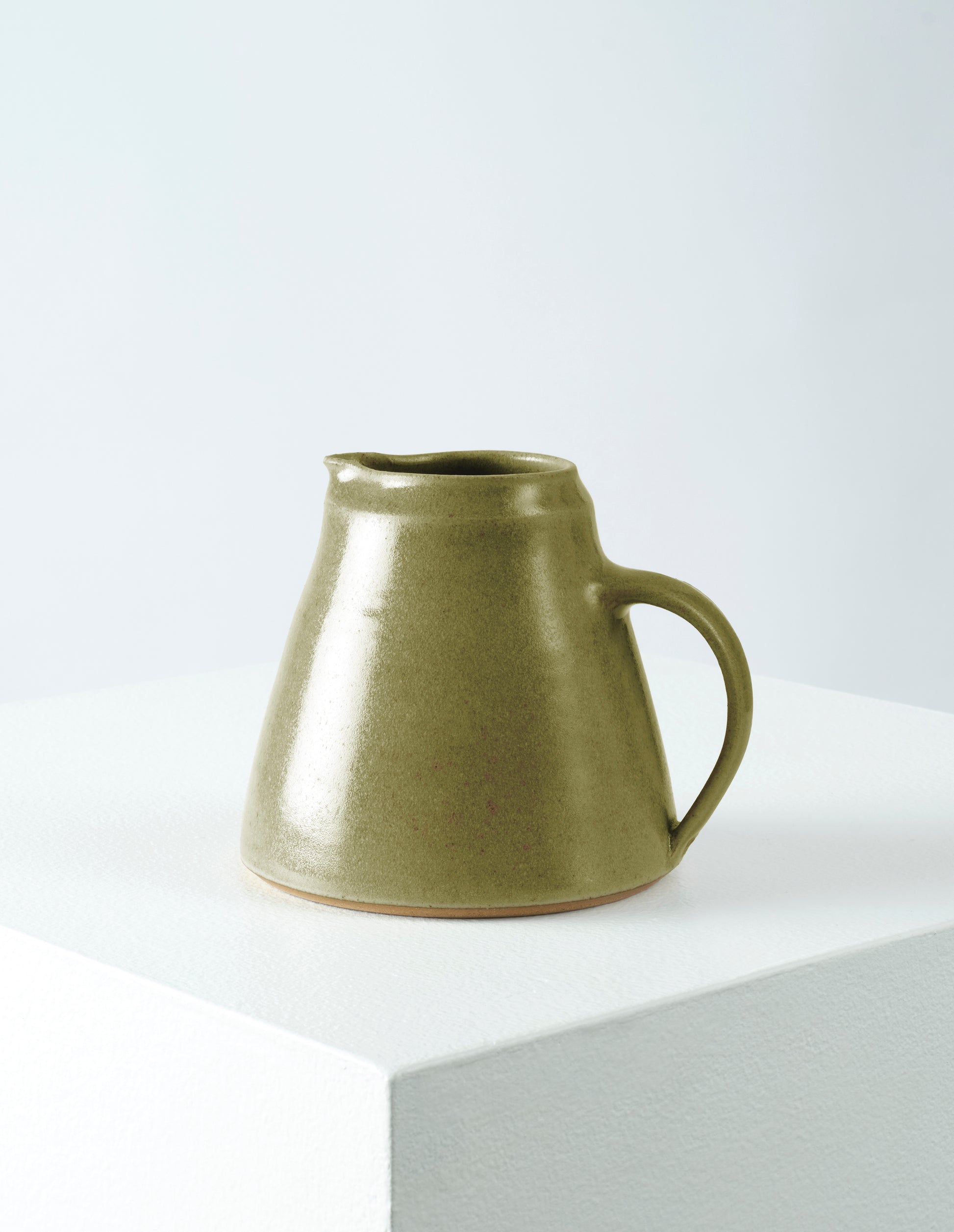 Front view of Nicola Tassie small soft green glazed stoneware jug.