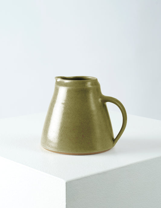 Front view of Nicola Tassie small soft green glazed stoneware jug.