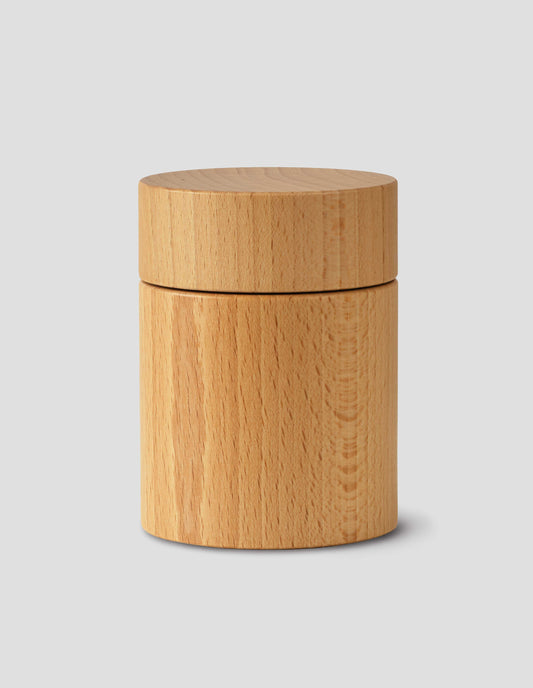 A front flay lay view of a wooden cylindrical salt and pepper mill.