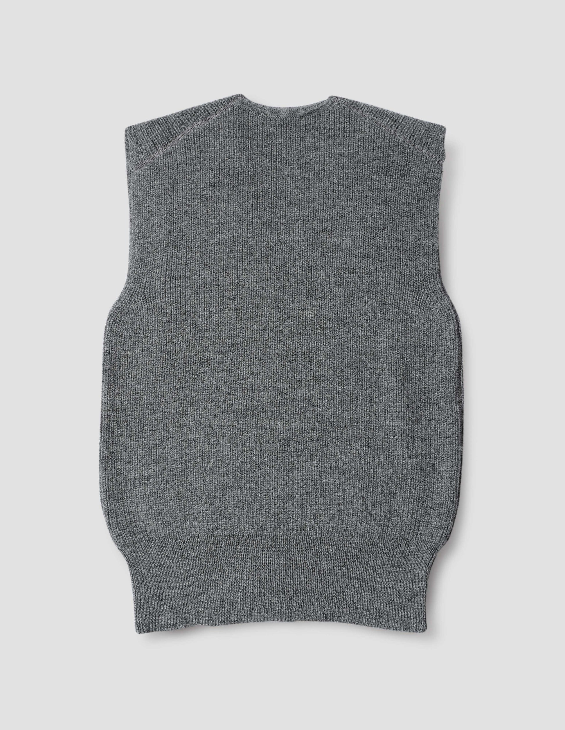 Grey sleeveless ribbed v neck slipover jumper, with contrast rib on hem. Back flat lay view.