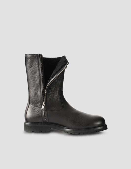 Black leather three quarter length boot with side zip, Vibram sole and shearling lining. Side view to display zip undone flat lay.