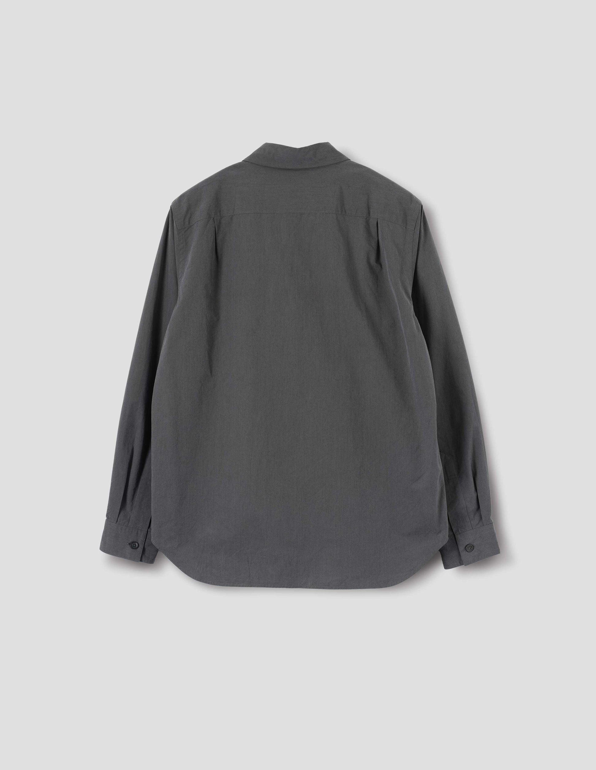 Dark grey shirt with curved hem, pleats on back yoke and horn buttons on cuffs. Back flat lay view.