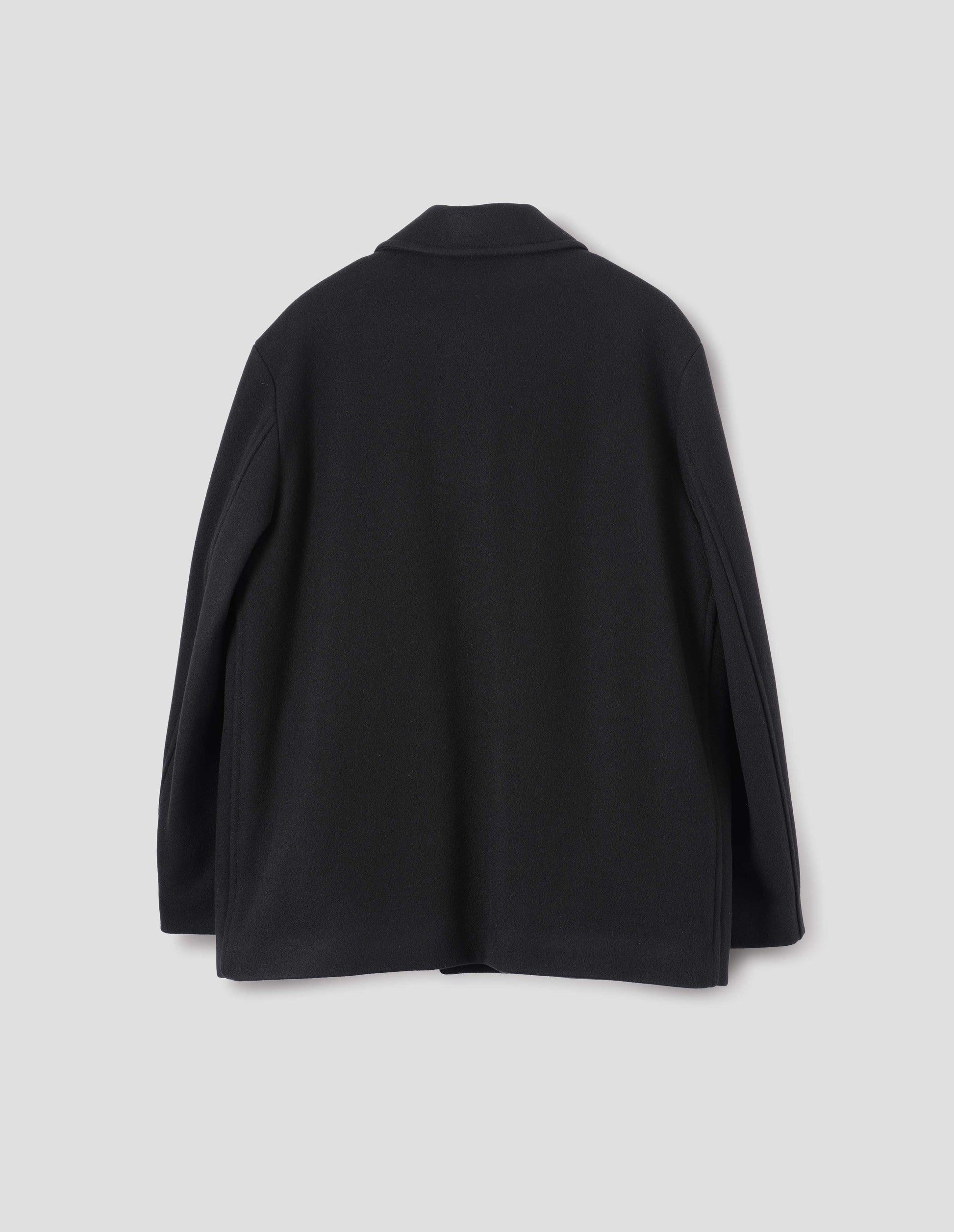 Black wool coat with stitch through detailing. Back flat lay view. 