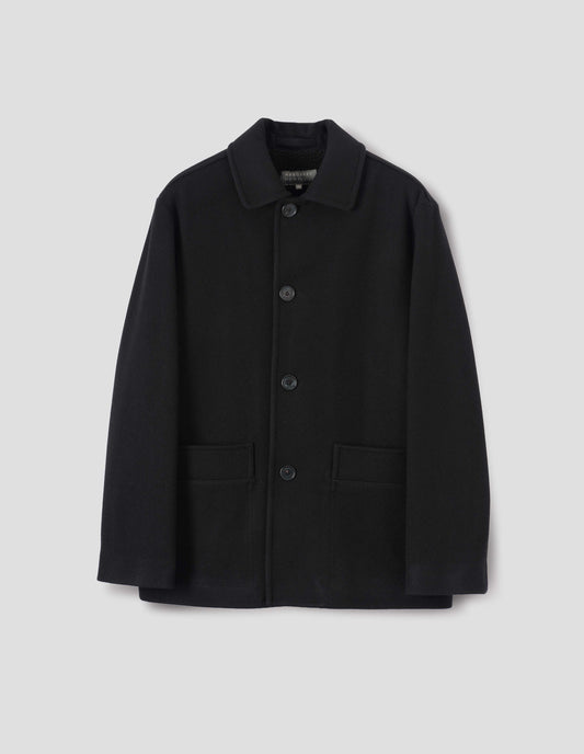 Black wool coat with contrast wool cotton fleece lining, with deep relaxed welt pockets and stitch through detailing. Finished with horn button closure. Front flat lay view. 