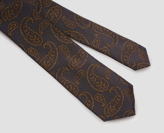 Dark grey and dark orange graphic paisley silk tie fabric swatch.