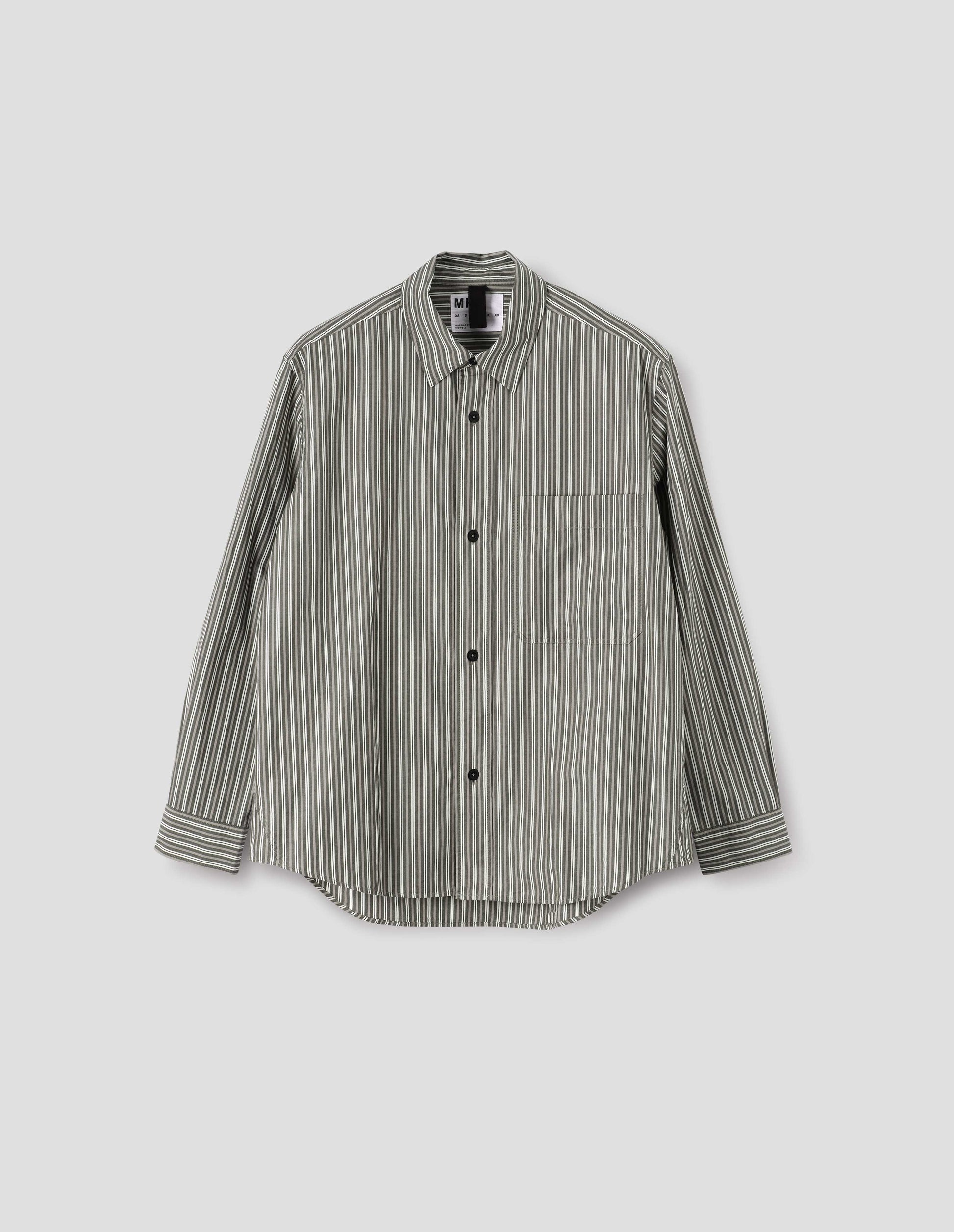 Green, grey and white striped cotton long sleeve shirt, with raised placket, large chest pocket, corozo button closure and side gusset stitch detailing. Front flat lay view.