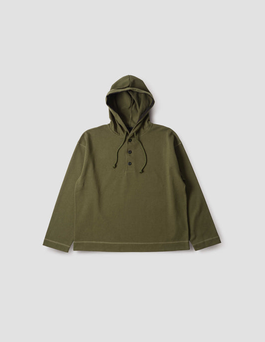 Green cotton hoodie, with drawcord hood, herringbone tape detailing, straight cuffs and stitch seam detailing, front flat lay view.
