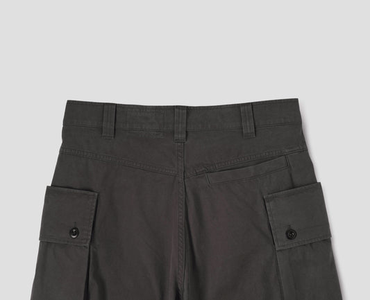 Brown cargo trousers with deep flap button fastening patch pocket, belt loops and welt pocket on back yoke. Back flat lay view.