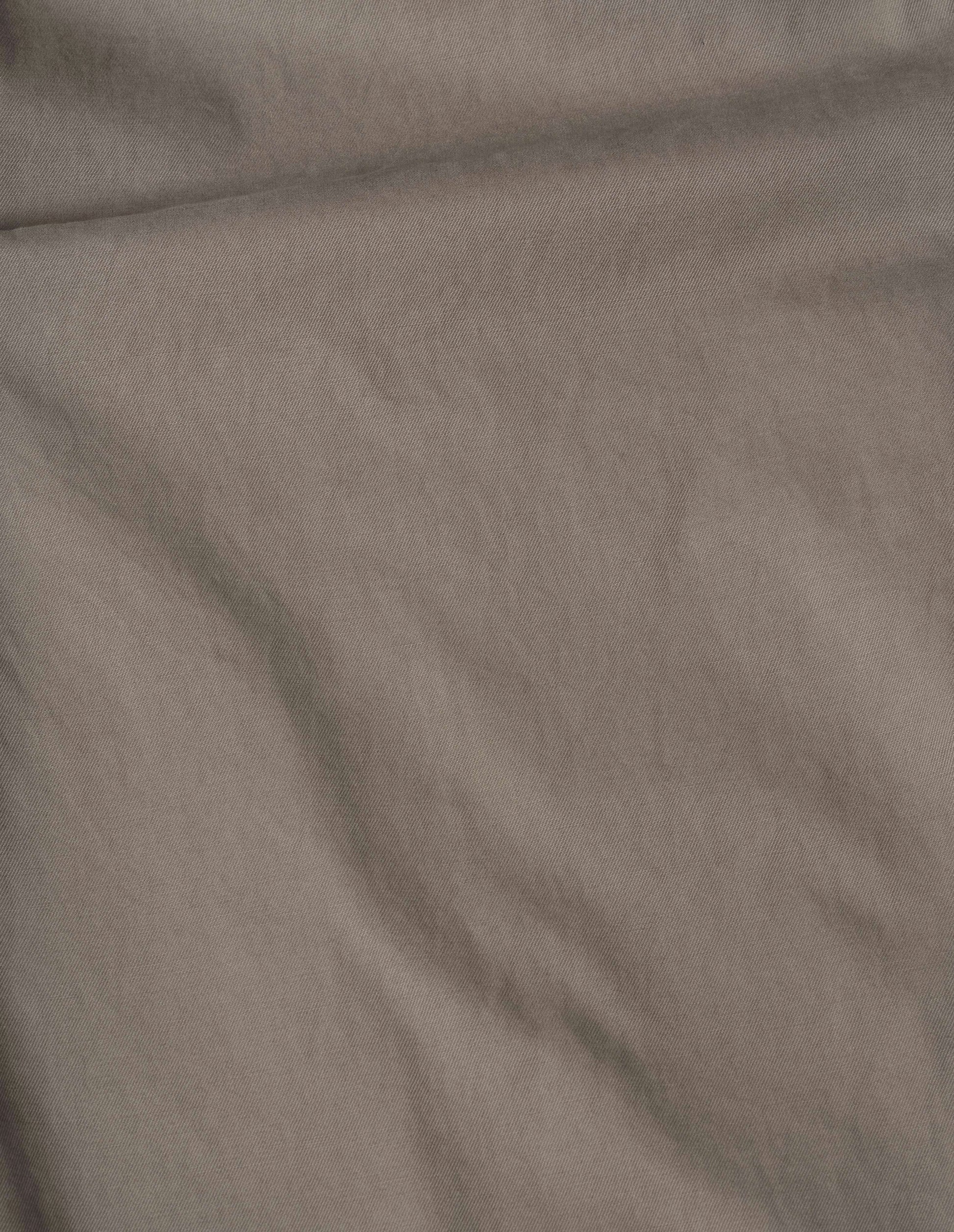 Beige plain cotton drill trousers, fabric swatch.