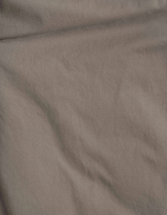 Beige plain cotton drill trousers, fabric swatch.