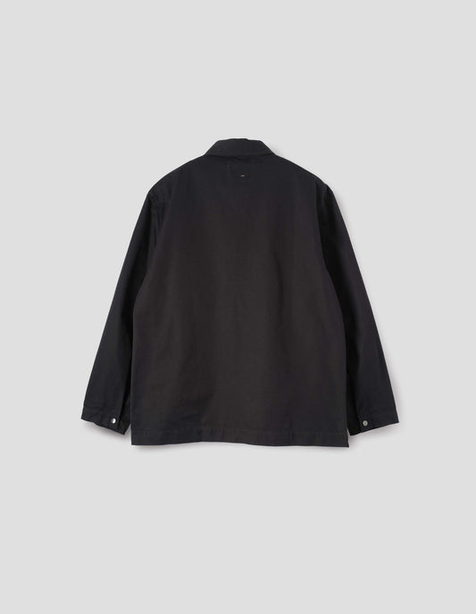 Black overshirt with button adjustable press stud cuffs and vent split hem. Back flat lay view. 