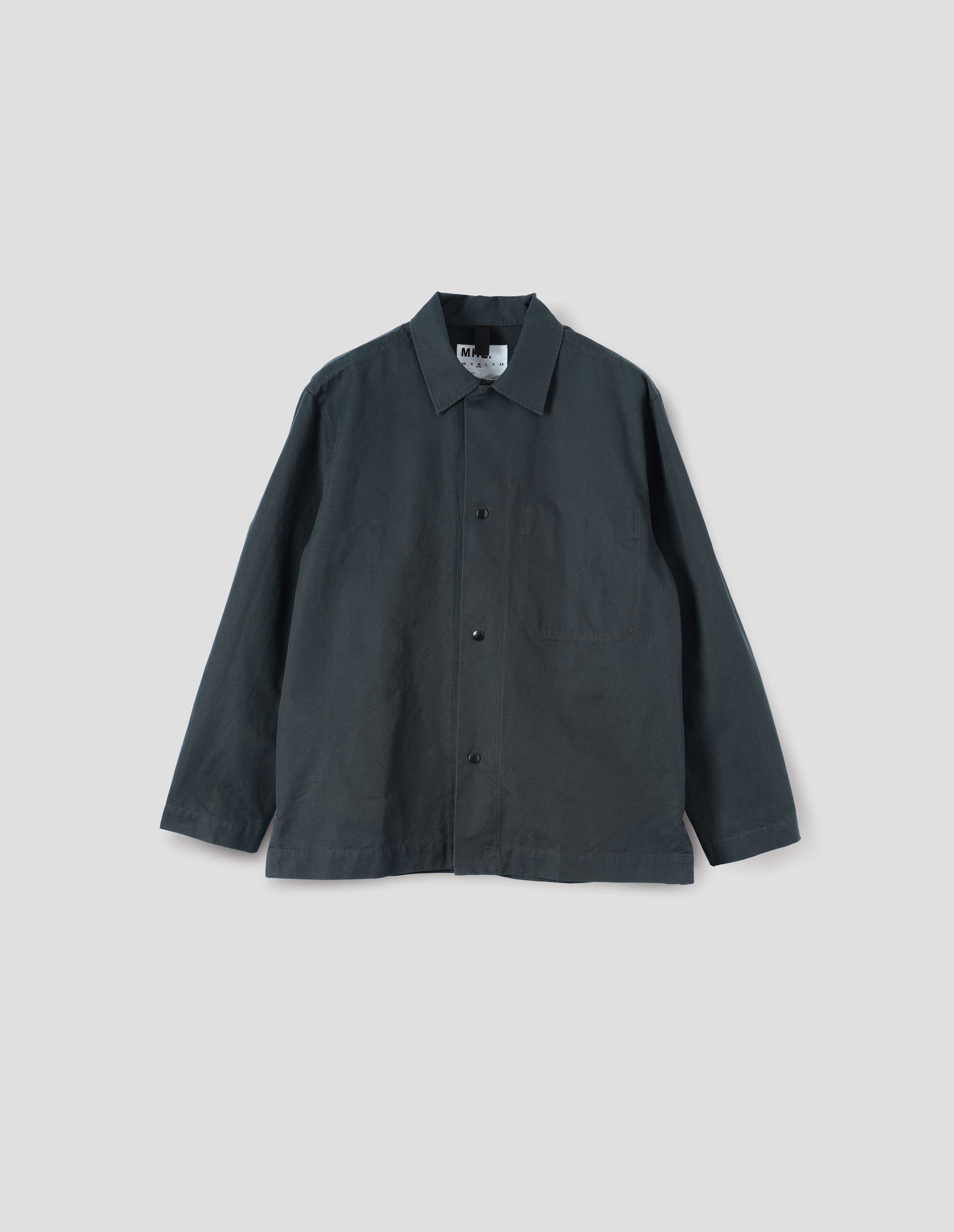 Teal blue overshirt with press stud fastenings, stitch through chest pocket and adjustable cuffs. Front flat lay view.