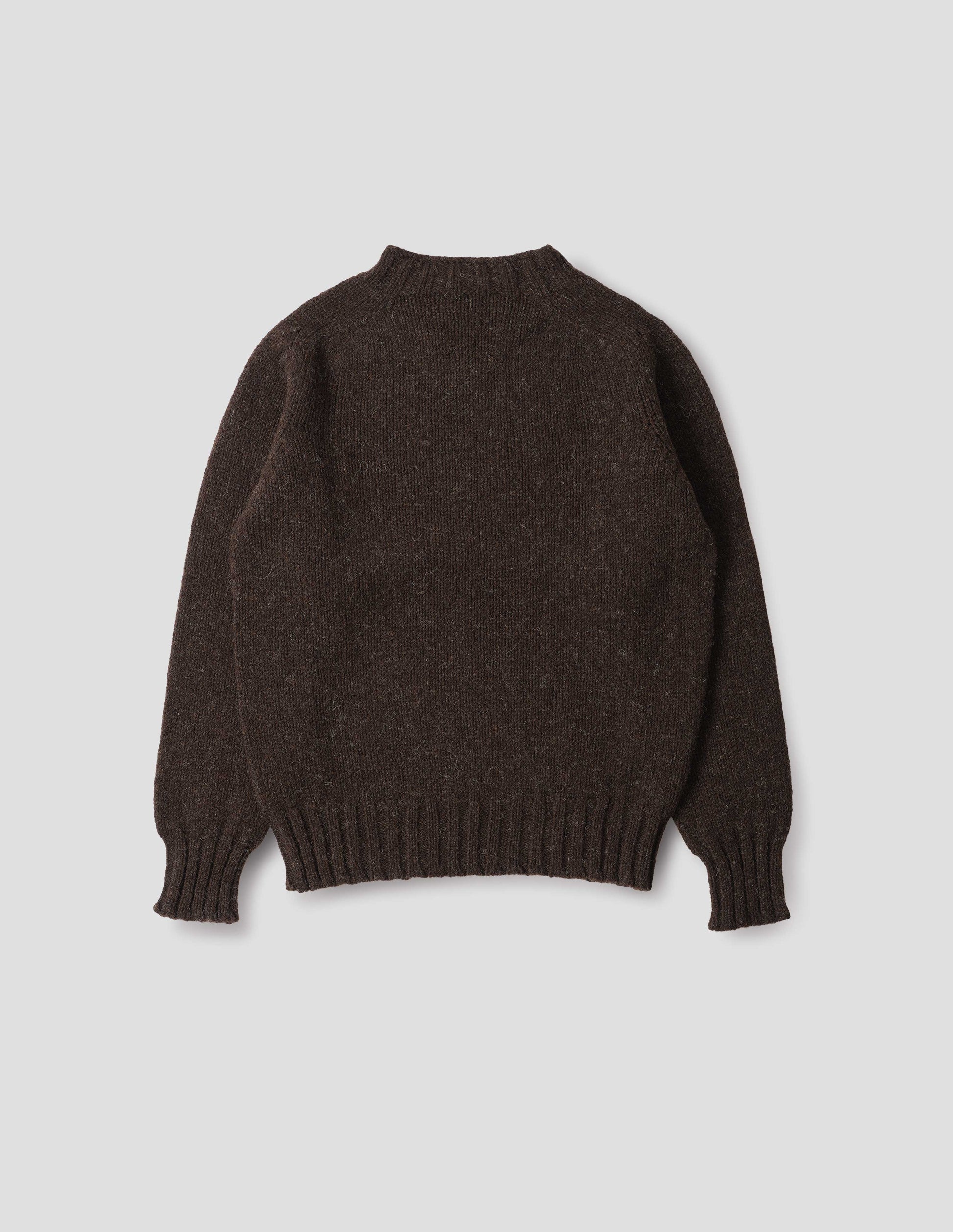 Dark brown marl jumper with saddle sleeves and contrasting rib on neck, cuffs and hem. Back flat lay view. 